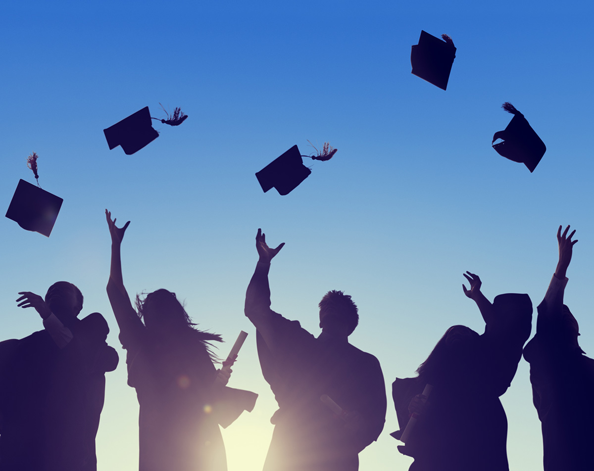 College graduates celebrate after graduating. Ginny Estupinian PhD teaches college resilience to entering college students