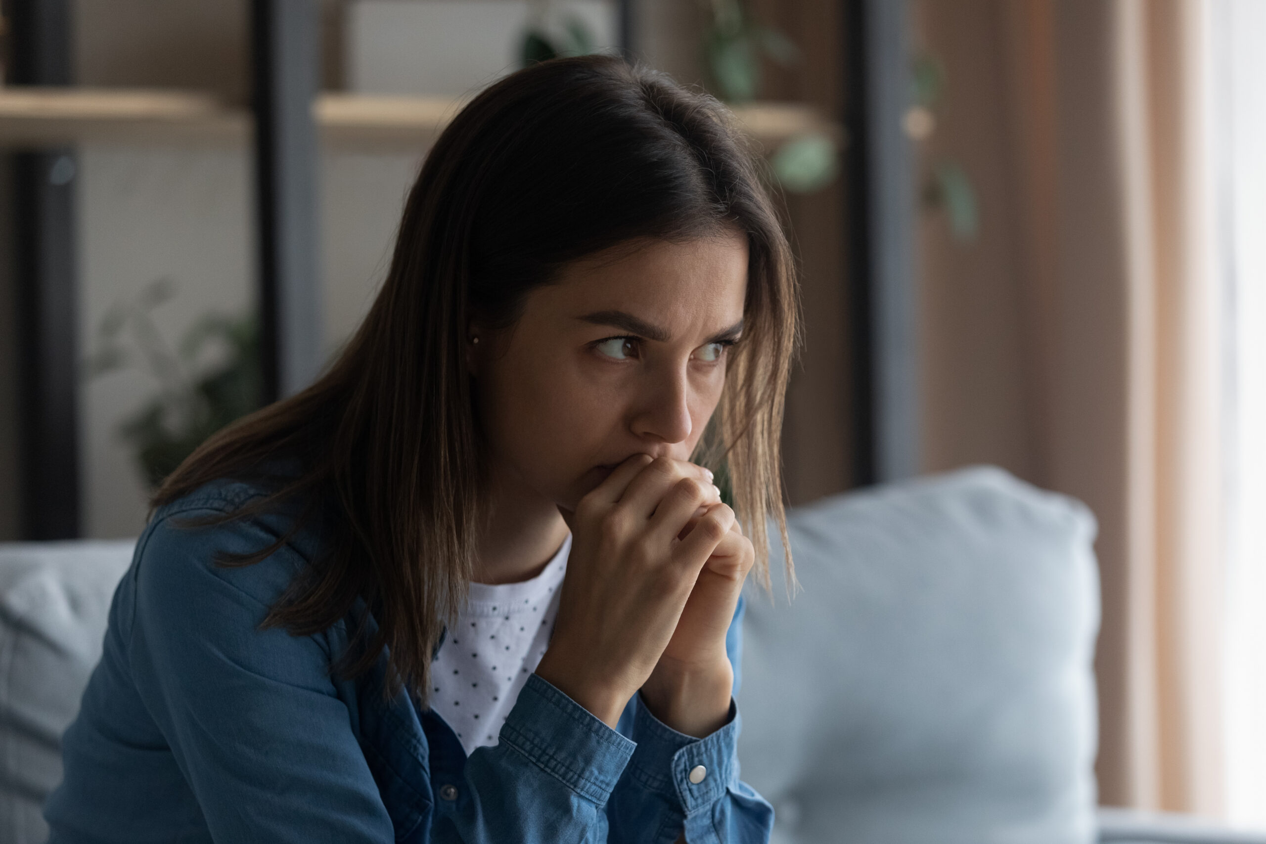 Photo of woman contemplating a difficult divorce and needing answers that Dr. Ginny Estupinian provides in her course Navigating the Storm: A Woman's Guide to Surviving a Bitter Divorce