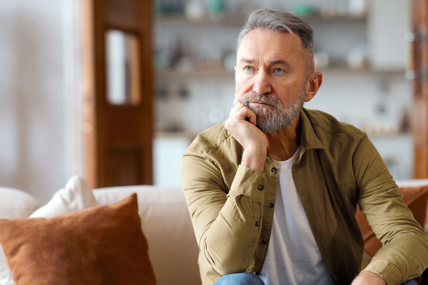 Photo of a man contemplating the divorce that is before him. Ginny Estupinian PhD provides guidance and strategies to get through a divorce